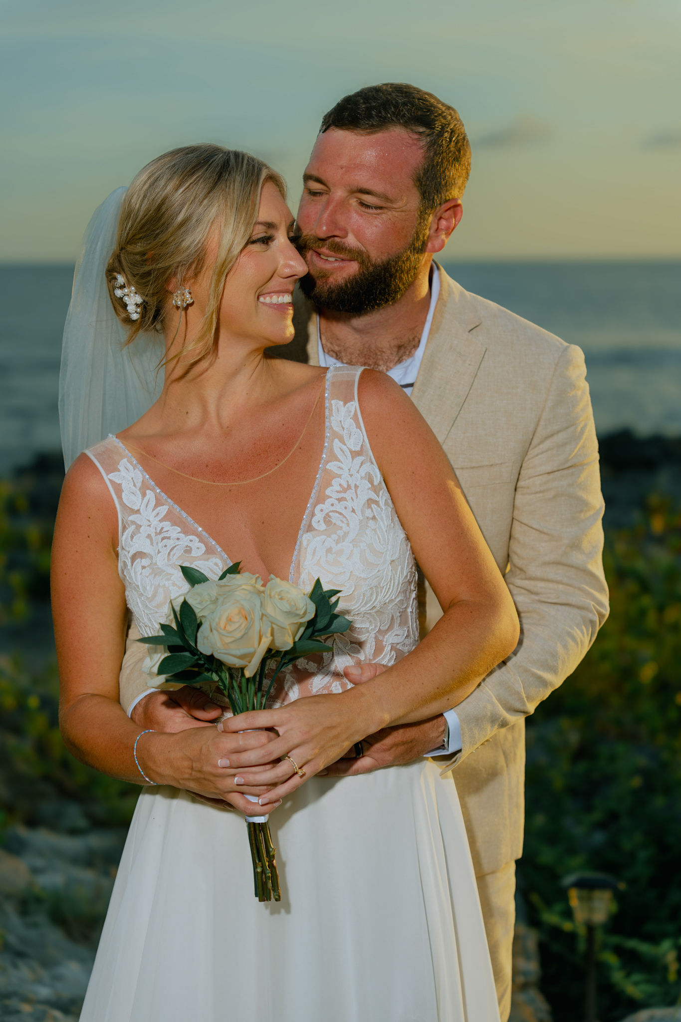 Jessie and Victor at golden hour, bride holding her bouquet