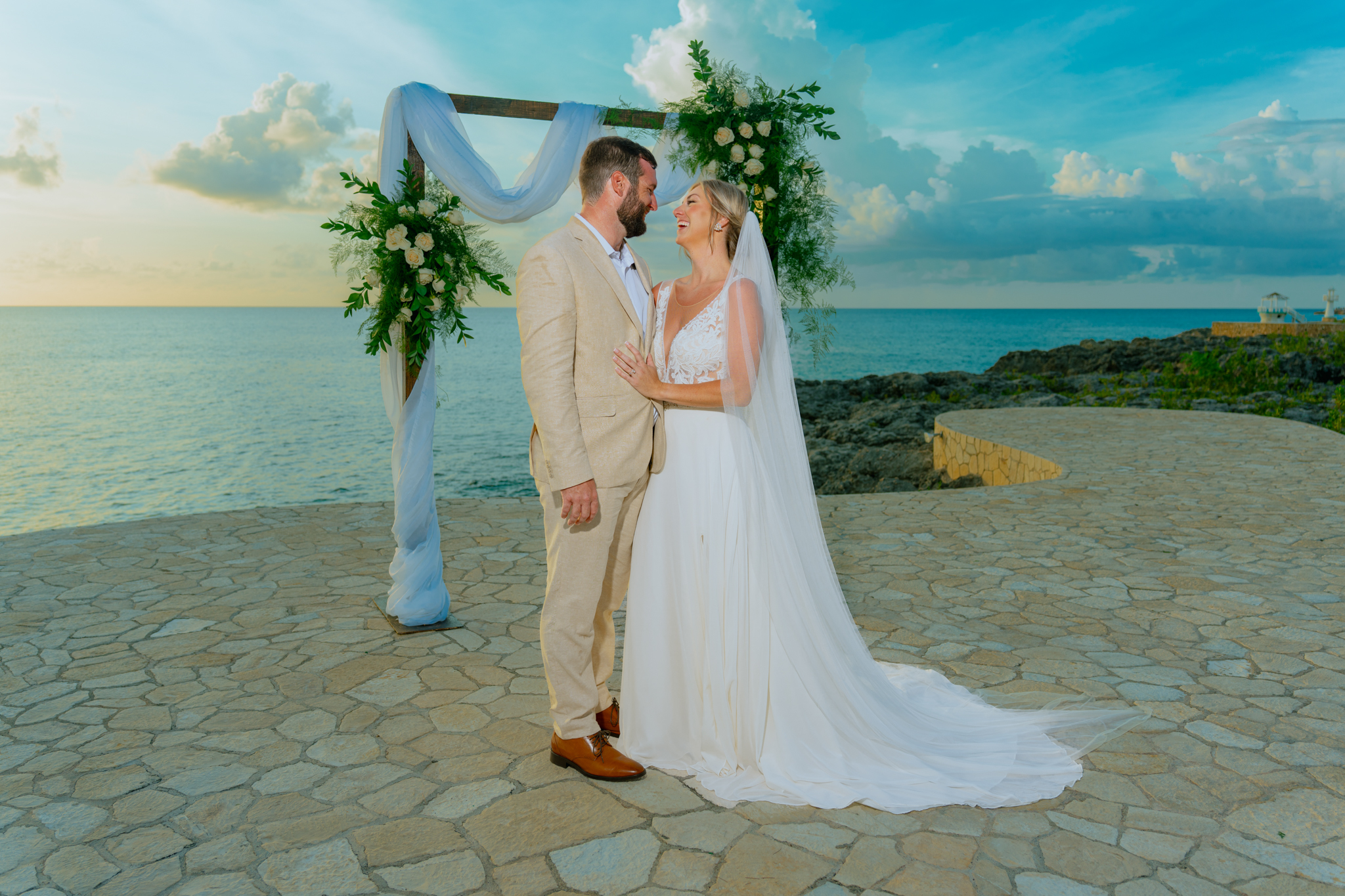 Jessie and Victor at the cliffside ceremony arch over the sea